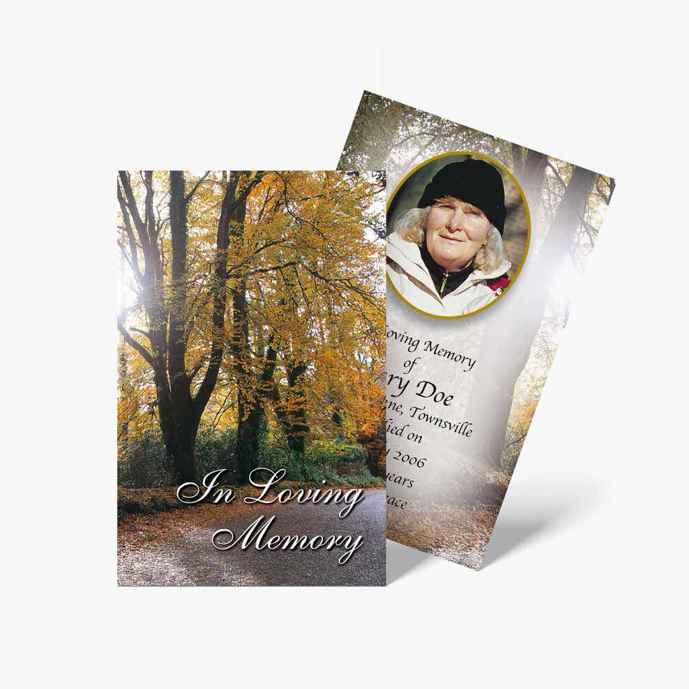 a funeral card with a photo of a woman in a forest