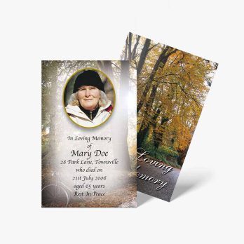 a funeral card with a photo of a woman in a forest