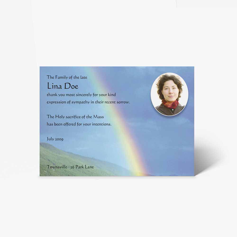 funeral card with a rainbow and a photo of a woman in a field
