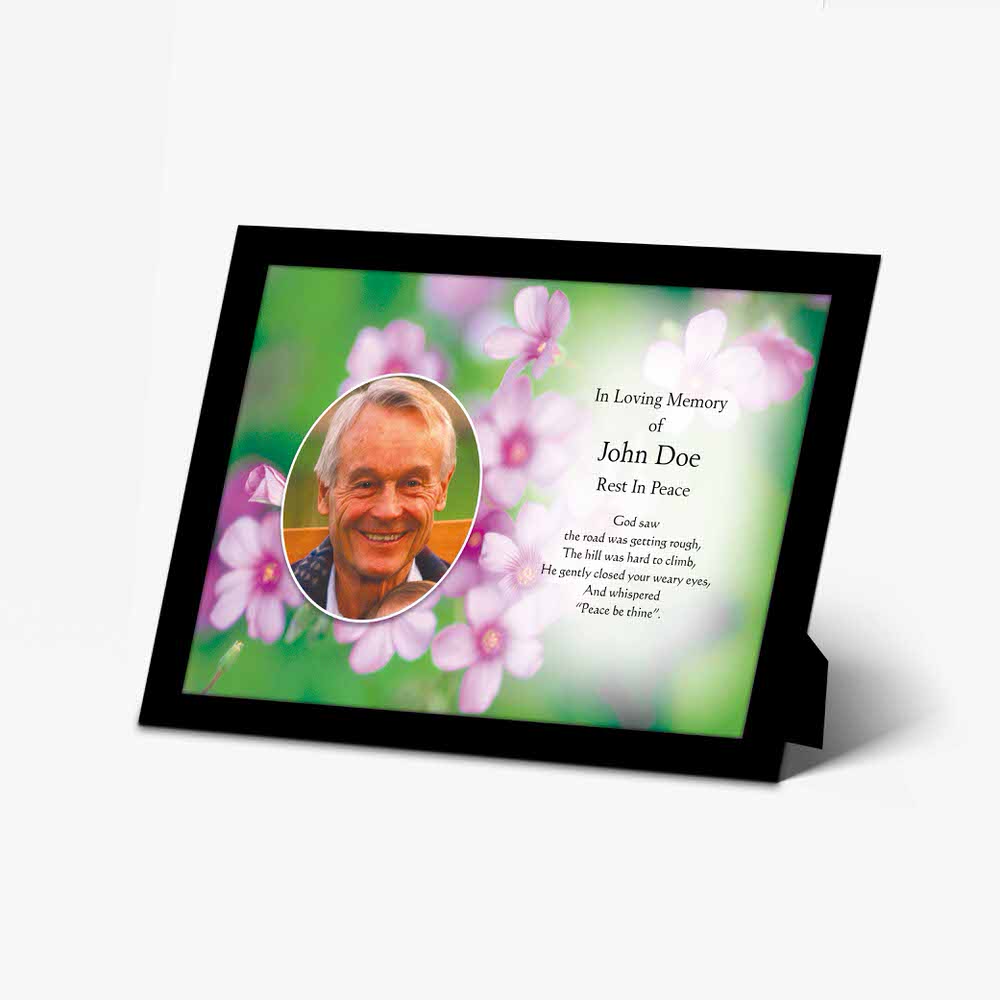 a memorial photo frame with a photo of a man in a flowery frame