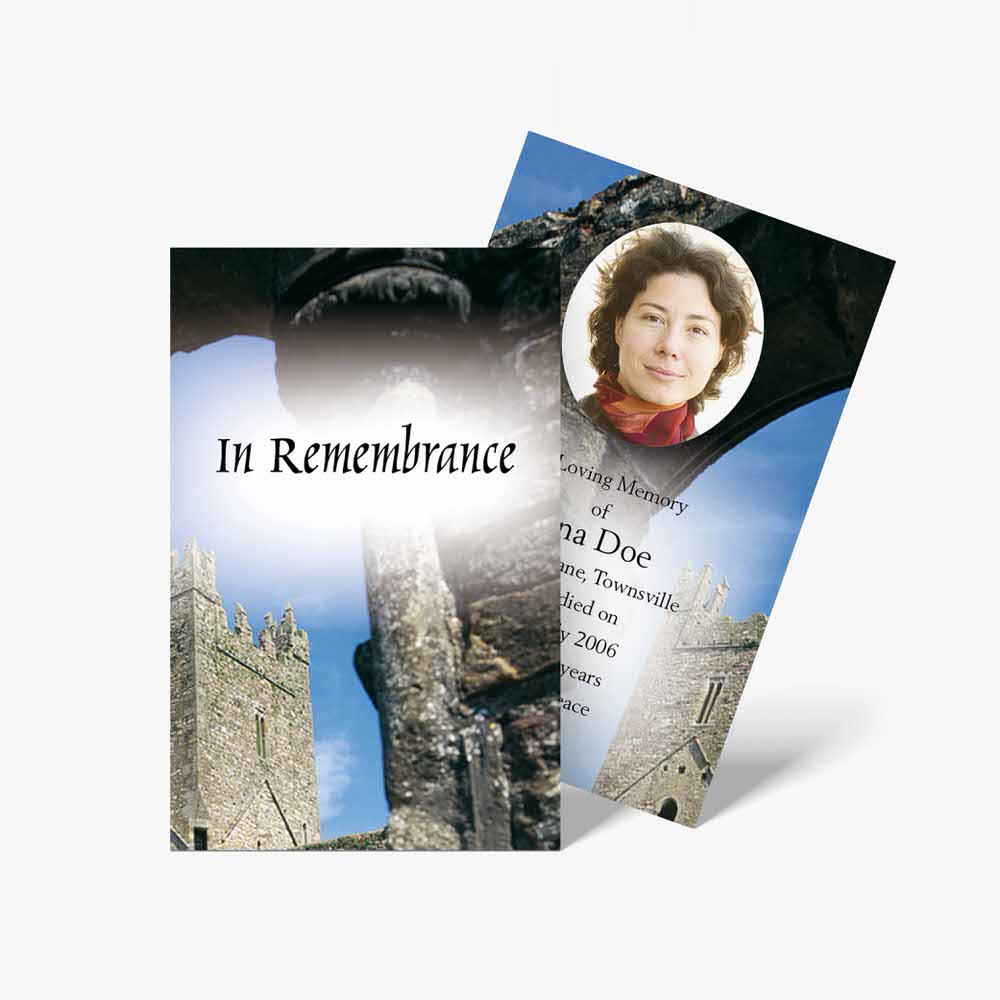 a memorial card with a photo of a woman in front of a castle