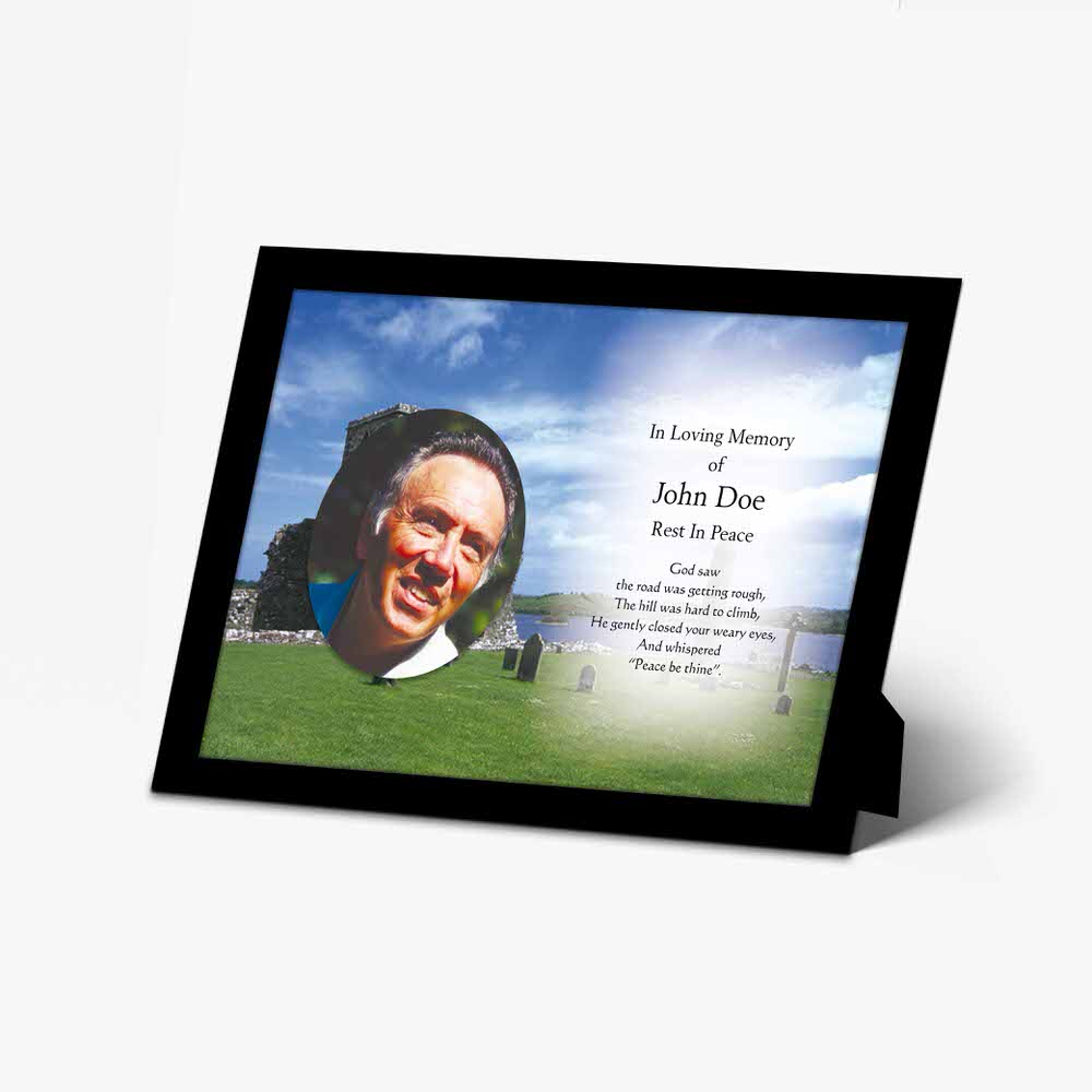 a memorial photo frame with a photo of a man in a field