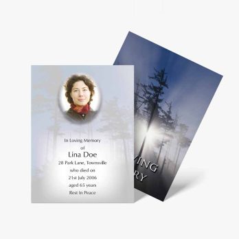 a funeral card with a photo of a woman in a forest