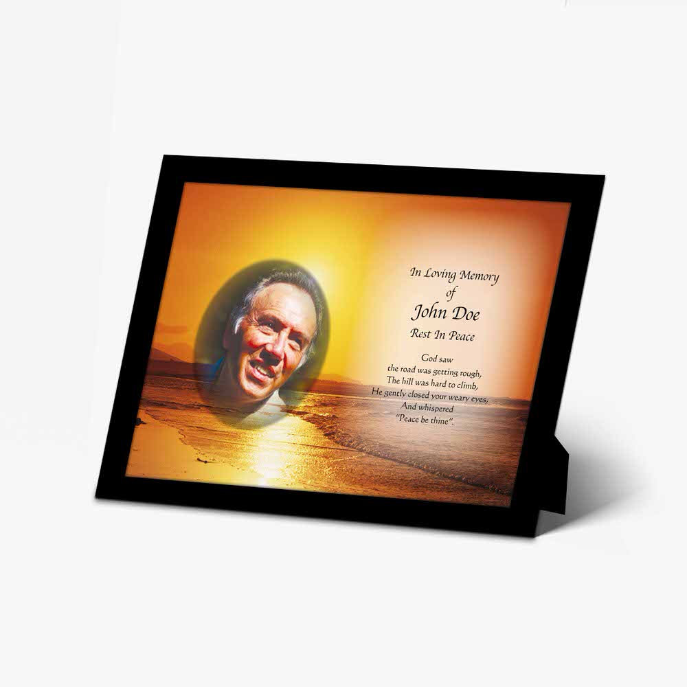 a memorial photo frame with a picture of a man on the beach
