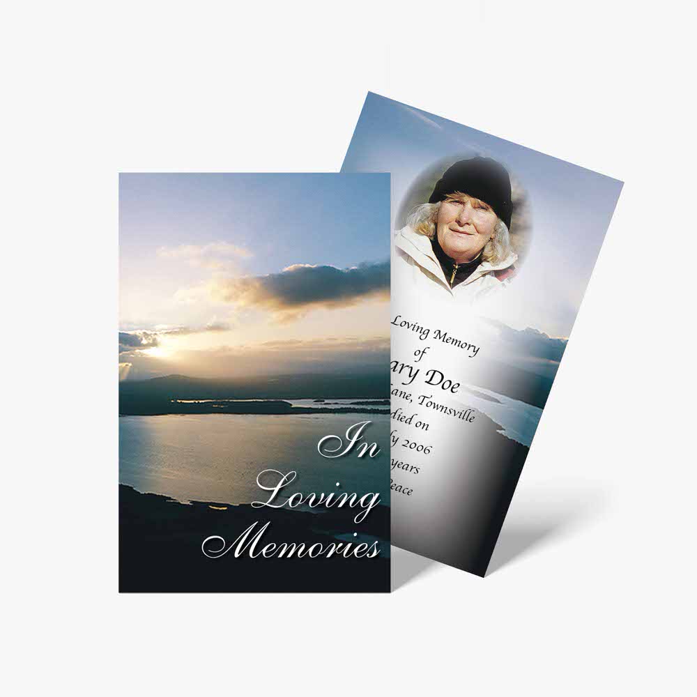 a funeral card with a photo of a woman on a mountain