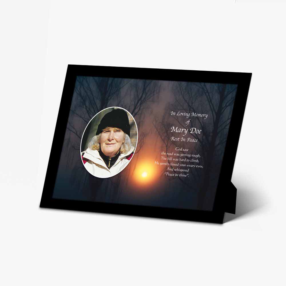 a memorial photo frame with a sunset in the background