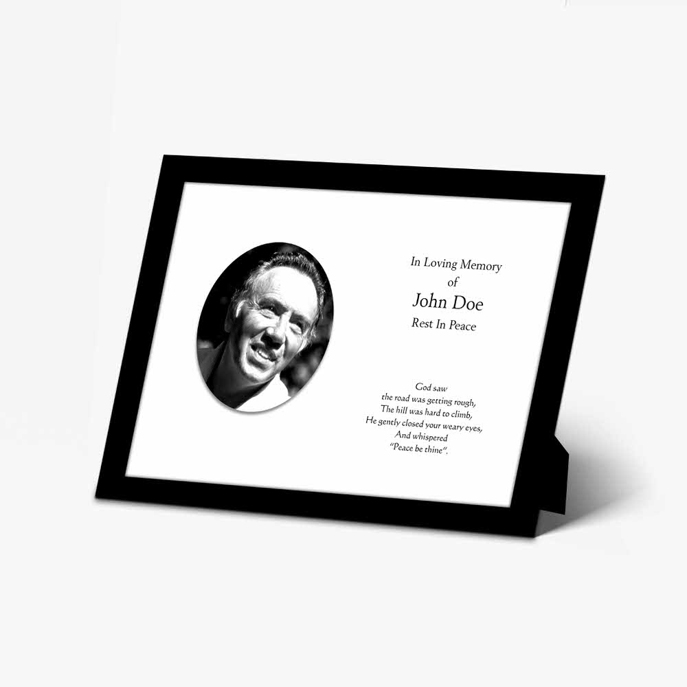 a memorial photo frame with a black and white photo of a man