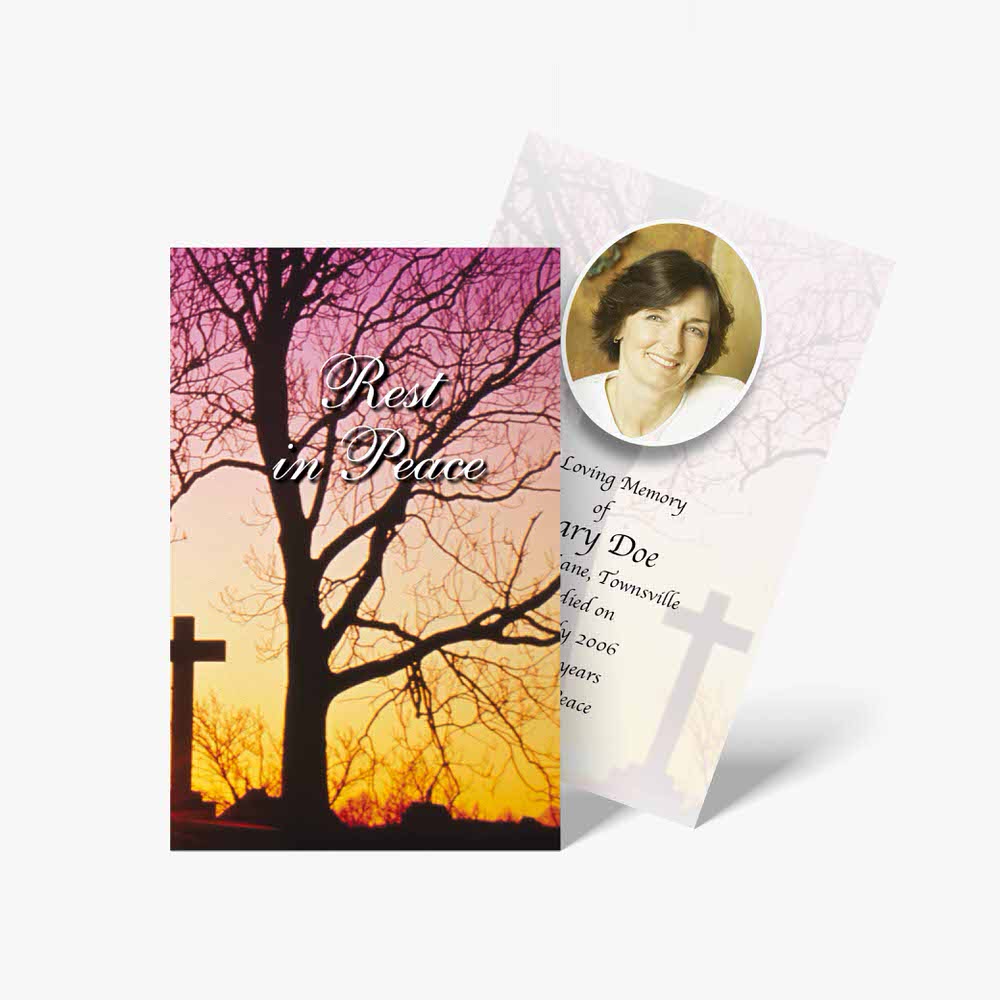 a funeral card with a tree and cross