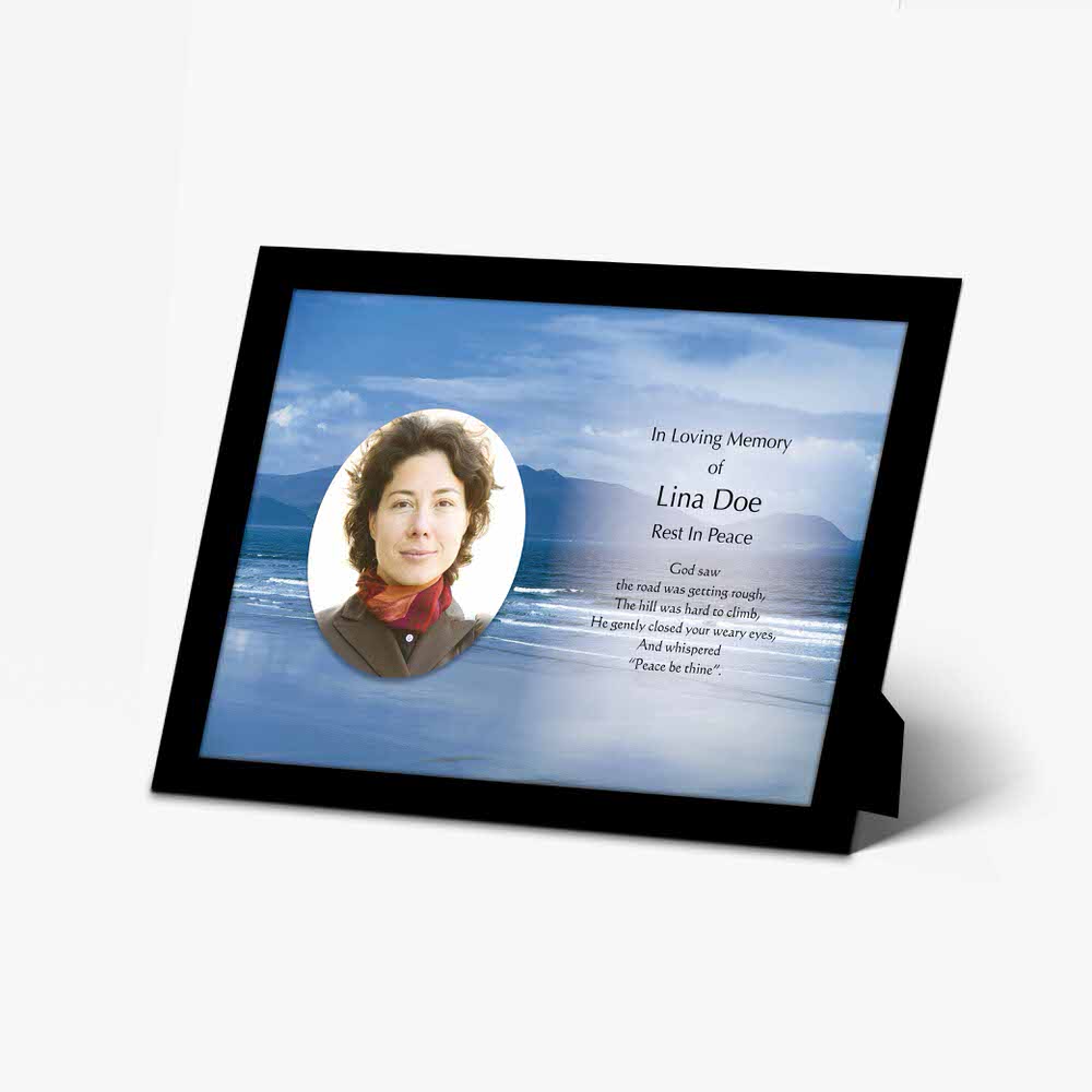 a memorial photo frame with a photo of a woman in a blue dress