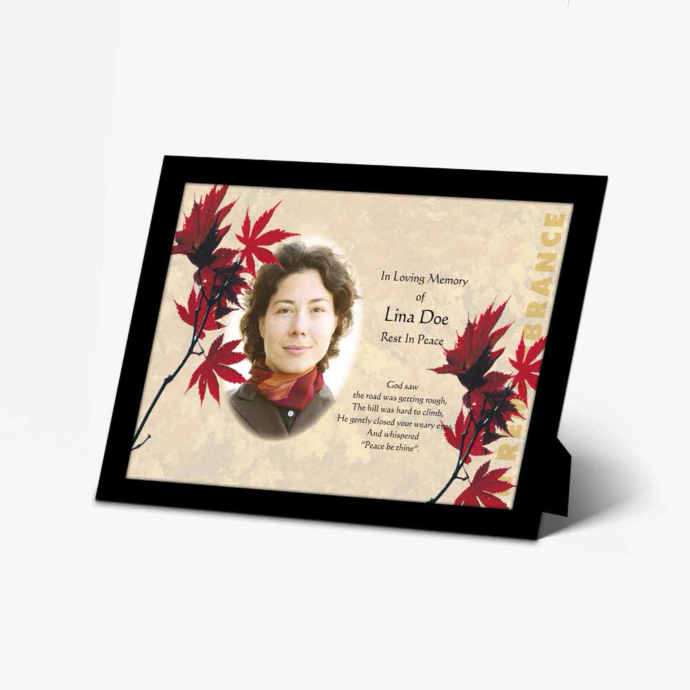 a beautiful memorial card with a red maple leaf design