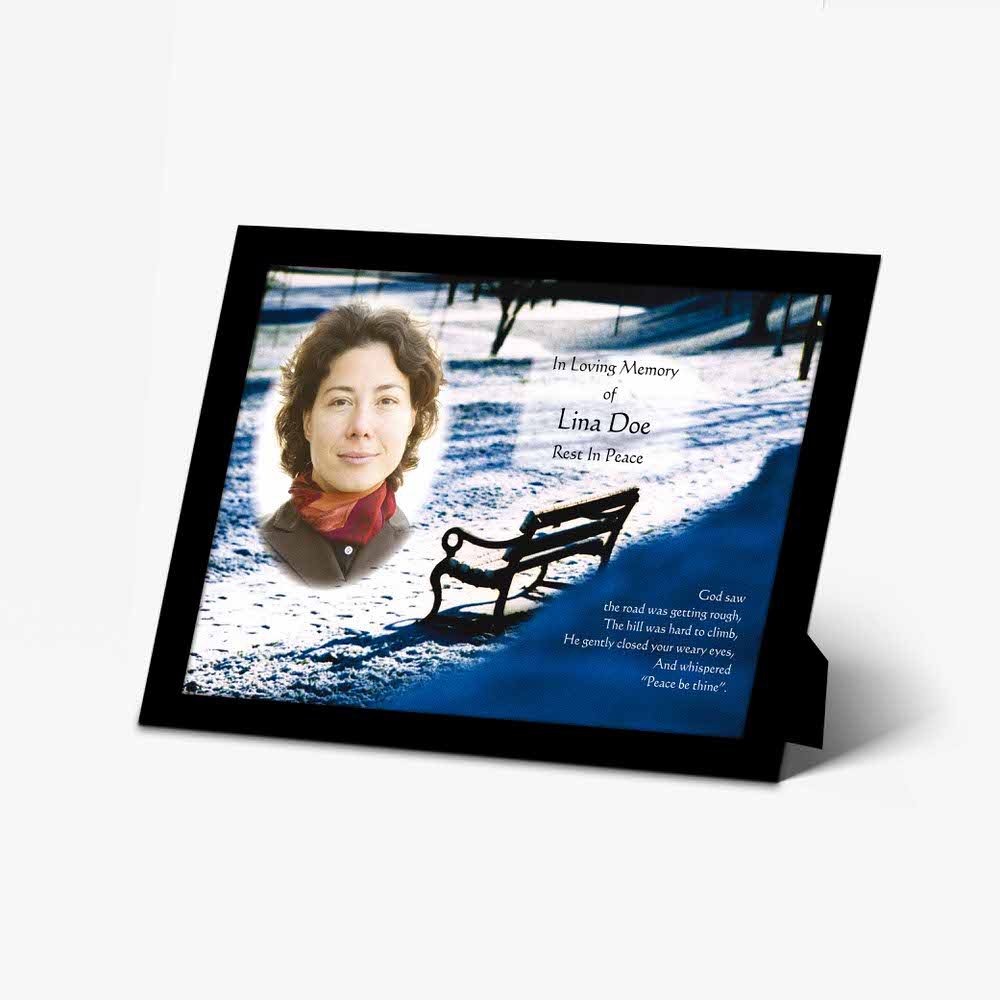 a memorial card with a photo of a woman sitting on a bench
