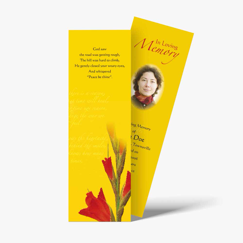 a yellow bookmark with red flowers on it