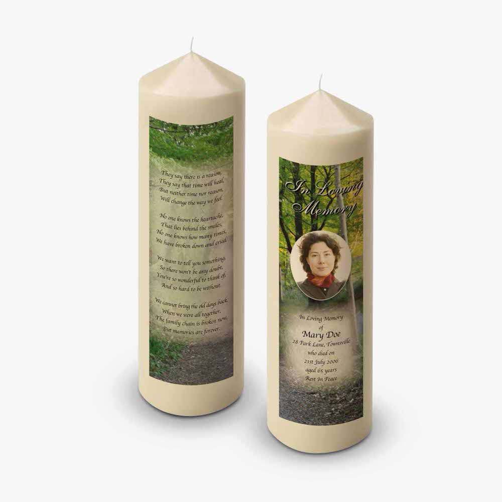 memorial candle with photo of a woman in the woods
