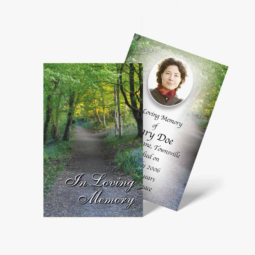 funeral cards with photos of a person in the woods