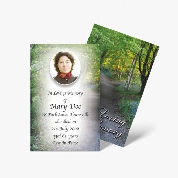 a funeral card with a photo of a woman in the woods