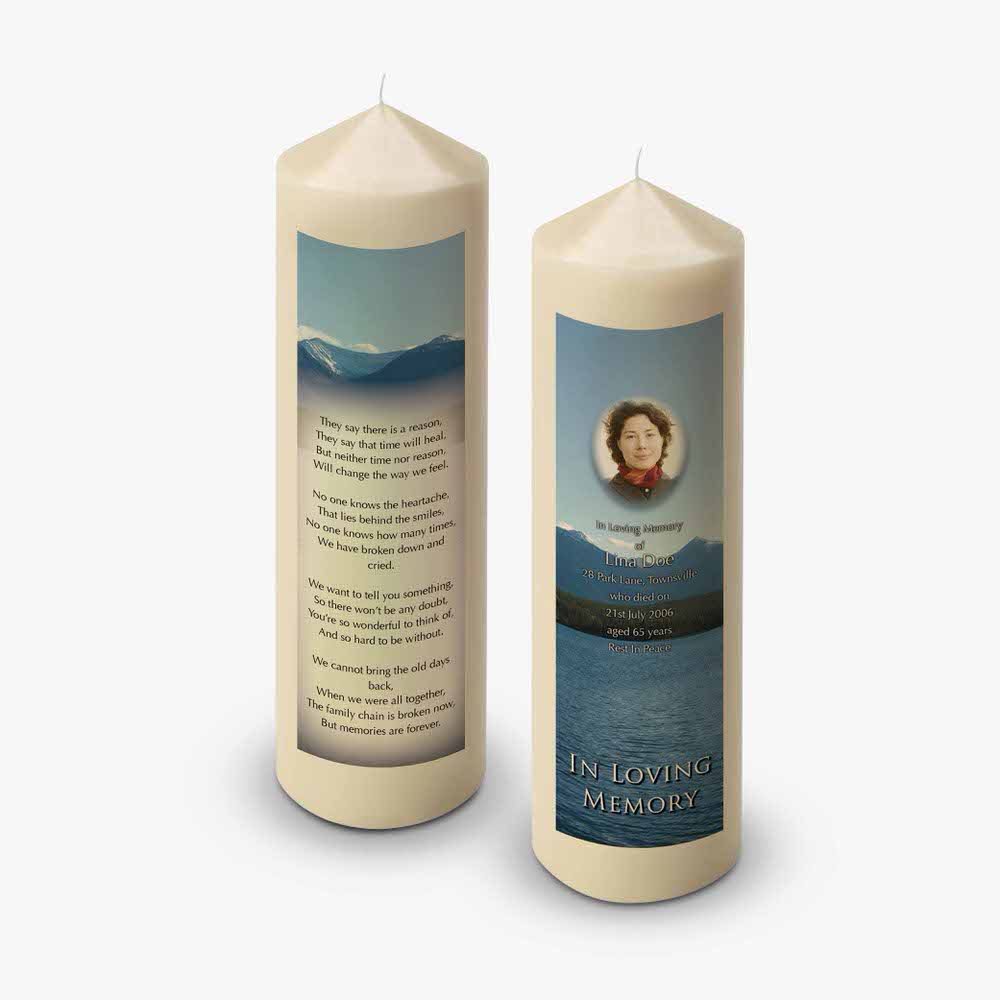 a candle with a poem on it and a picture of a lake