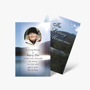 a funeral card with a photo of a woman on a lake