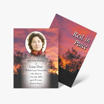 a funeral card with a sunset in the background