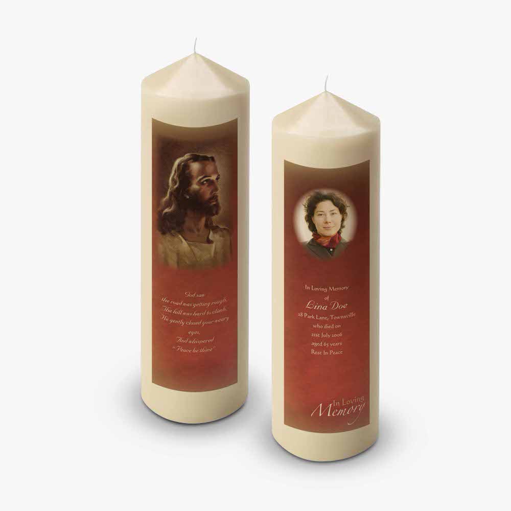 two candles with a picture of jesus on them
