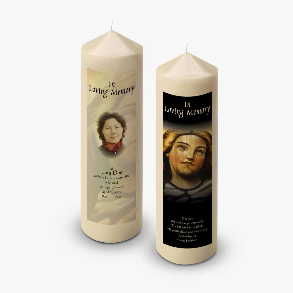 two candles with pictures of saints on them