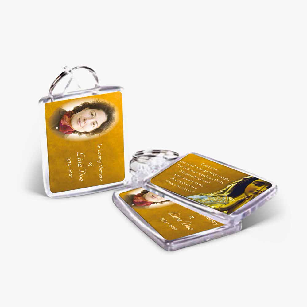 a yellow and black keychain with a photo of a woman