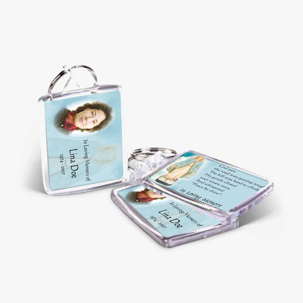 a key chain with a picture of a woman and a prayer card