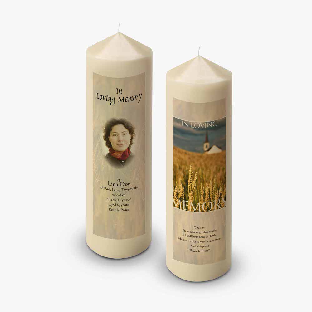 a candle with a picture of a woman in a wheat field