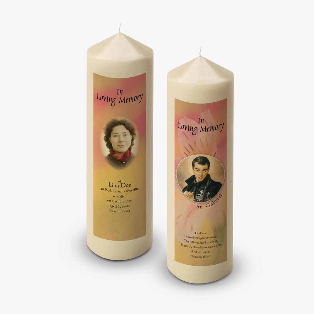 two candles with pictures of people on them