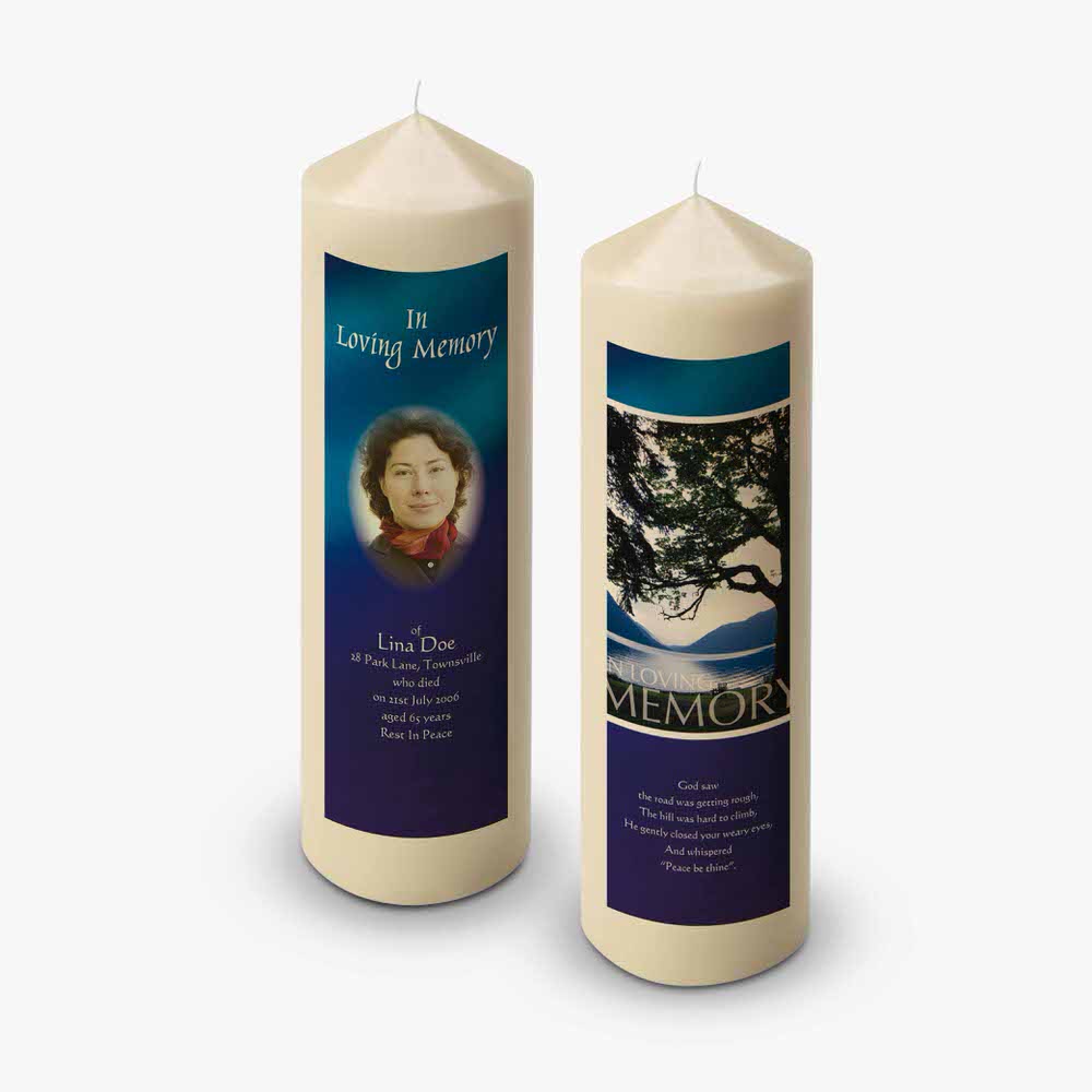 two candles with pictures of a woman and a tree