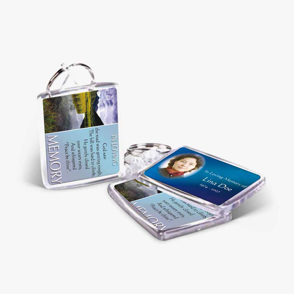 a key chain with a picture of a mountain and a person