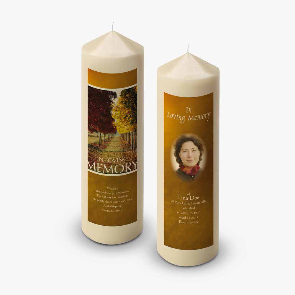 two candles with an image of a woman and a tree