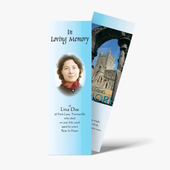 a blue bookmark with a photo of a woman in front of a church