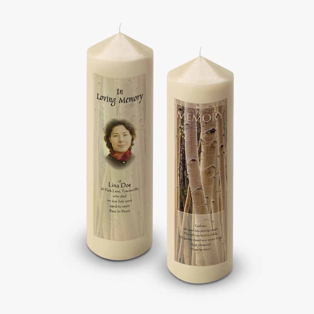 a candle with a photo of a woman and a tree