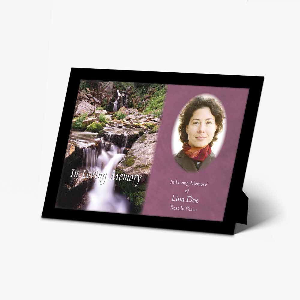 a memorial photo frame with a waterfall and a woman's face