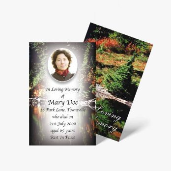 a funeral card with a photo of a woman in the woods