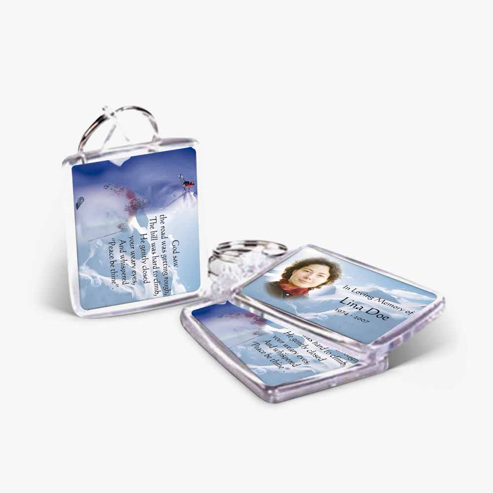 two key chains with a picture of a snow covered mountain