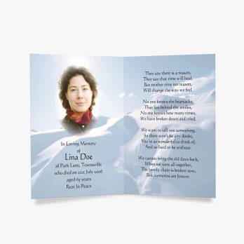 memorial card with photo of a woman in the snow