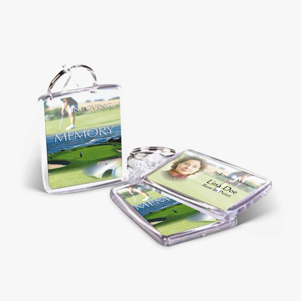 a clear keychain with a picture of a golf course
