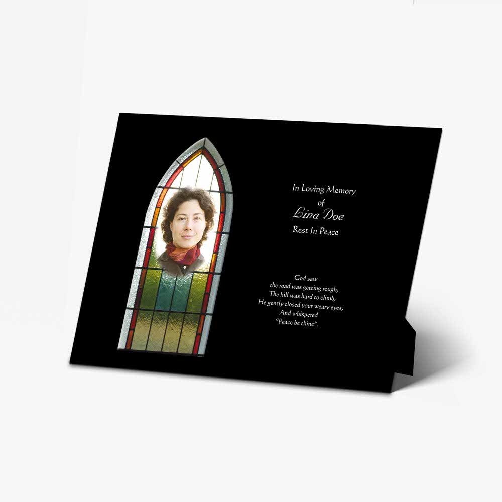 a memorial card with a photo of a woman in a window