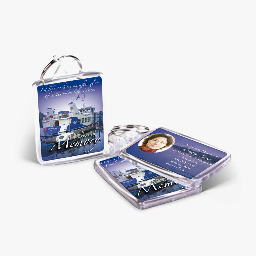 a key chain with a photo of a ship and a picture of a city