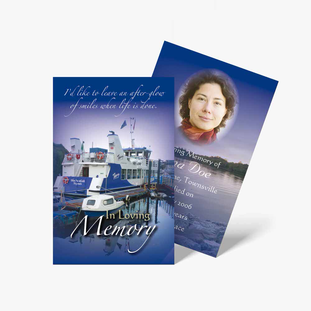 a memorial card with a boat and a woman's face