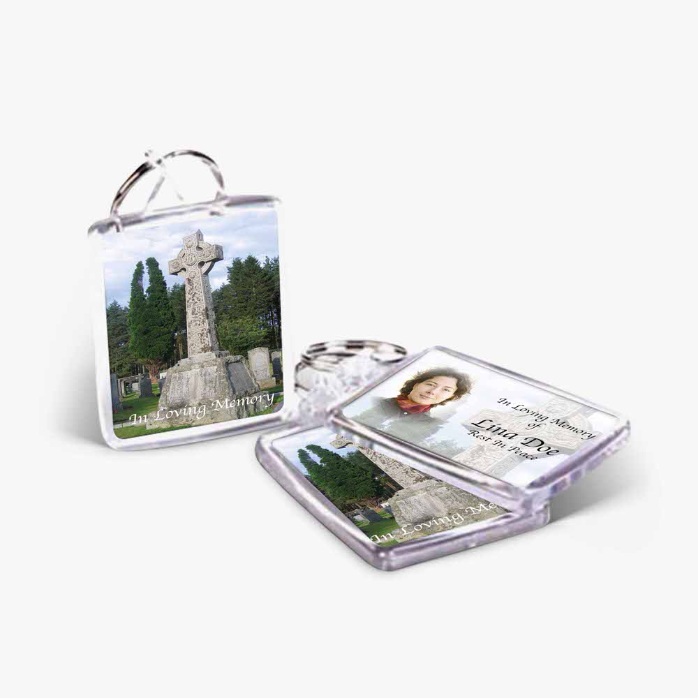 a photo keychain with a photo of a church and a cross