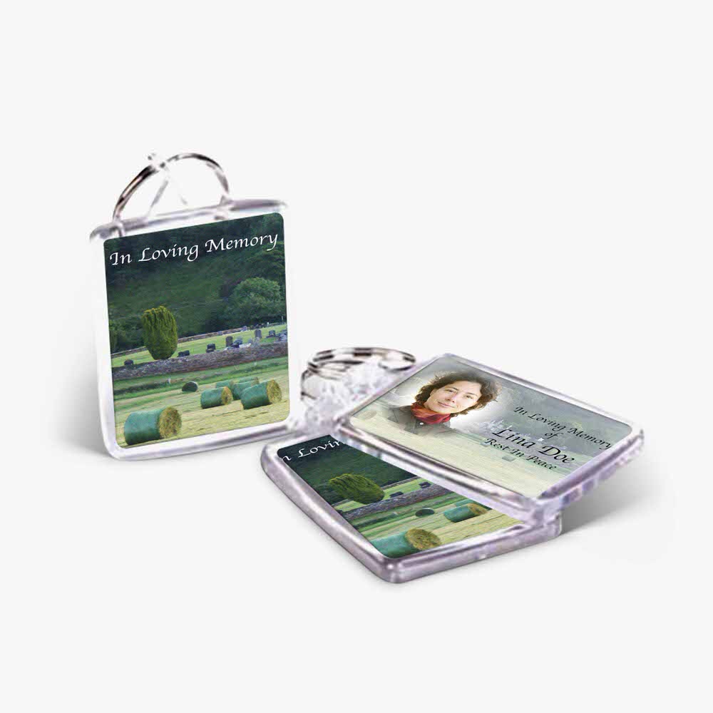 a keyring with a photo of a field and a picture of a person