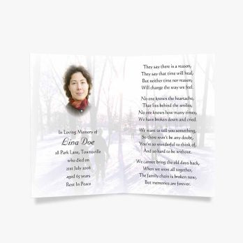 a memorial card with a photo of a woman in the snow