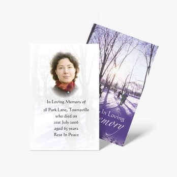 a memorial card with a photo of a woman in the snow