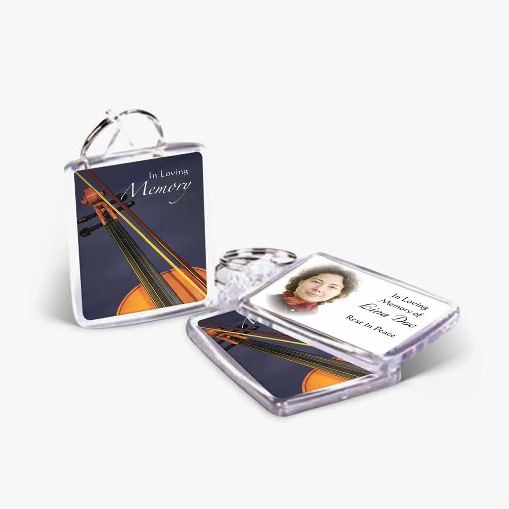 a photo keychain with a violin and a photo