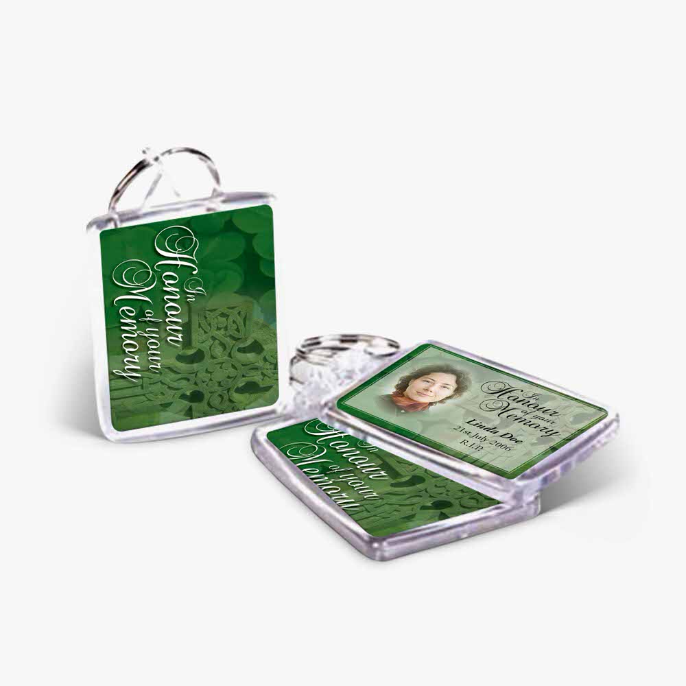 a green keychain with a picture of a woman