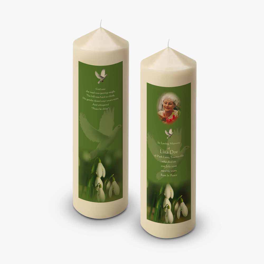 two candles with a picture of a woman and flowers