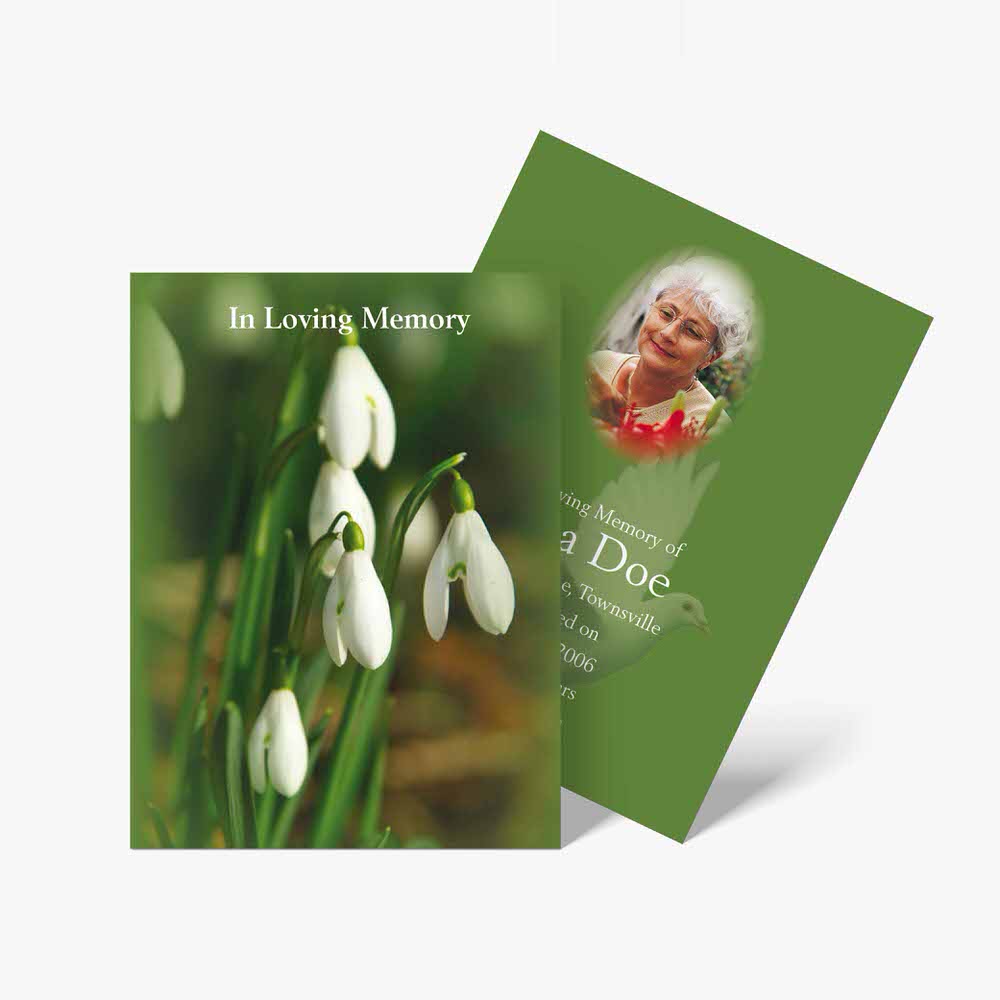 a funeral card with snowdrops and a photo of the deceased