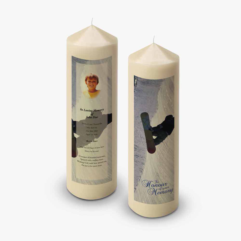 two candles with a picture of a snowboarder on them